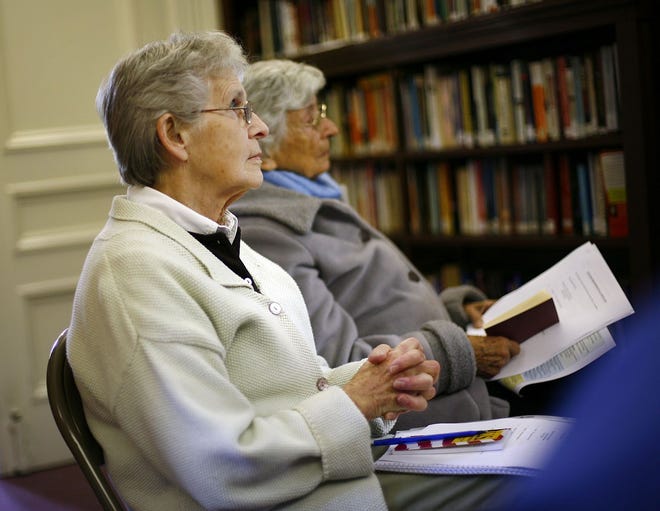 Joan Kenworthy of Rockland, left, and Winnie-Lou Rounds of Scituate listen to Carol Neely talk about the Constitution.