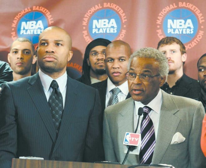 Billy Hunter (right), National Basketball Players Association
executive director, speaks to the media while association president
Derek Fisher listens in New York Monday. NBA players rejected the
league's latest offer and have begun the process to disband the
union.