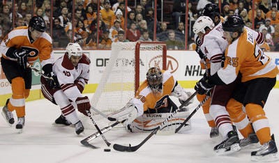 Flyers goalie Ilya Bryzgalov battles a crowd of players for puck
in Thursday night's game vs. Phoenix.