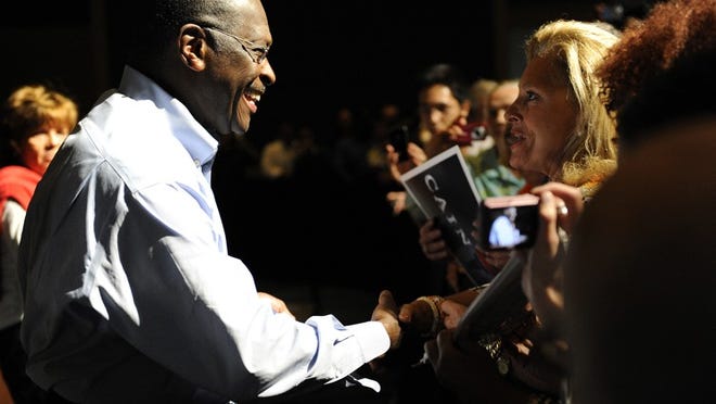 Herman Cain speaks to supporters at a Wednesday night rally at the Palm Beach County Convention Center in West Palm Beach.