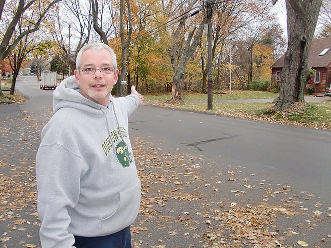 Kevin Gracia, a Cohannet Street resident of 10 years, point to the site of a early Sunday morning truck versus tree crash. Gracia and other neighbors say motorists constantly flout speed restrictions on the residential road.