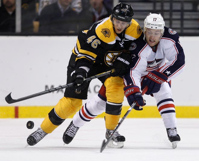 Boston Bruins center David Krejci, left, and Columbus Blue Jackets center Mark Letestu chase the puck during the second period of an NHL game in Boston, Thursday, Nov. 17, 2011.