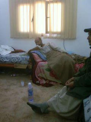 This image from Libyan television and made available by the Libyan Outreach group via Facebook, Saturday, Nov. 19, 2011, purportedly shows Seif al-Islam Gadhafi in custody in an undisclosed location. Moammar Gadhafi's son Seif al-Islam, the only member of the ousted ruling family to remain at large, was captured as he traveled with aides in a convoy in Libya's southern desert, Libyan officials said Saturday. (AP Photo/Libyan TV via Libyan Outreach)