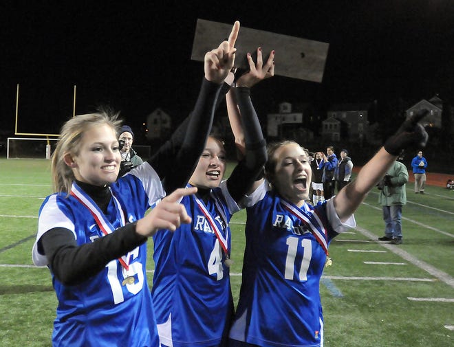 Dover-Sherborn's Elizabeth McMillen (left), Victoria Ortega (center) and Maddie Dunn hoist the Division 3 championship trophy after defeating Hopedale Friday in Worcester.