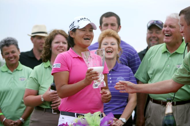 Yani Tseng accepts the Bruce Callis Memorial Trophy with a little champagne in it after winning the State Farm Classic at Panther Creek Golf Club Sunday, June 12, 2011.