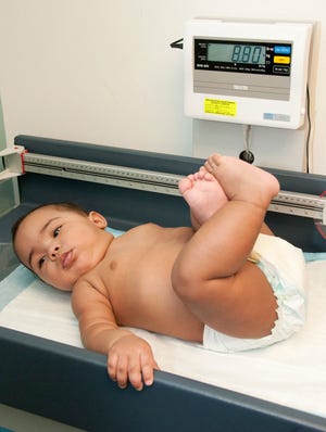 An infant's growth is measured during a check-up at Children's Hospital Boston.
