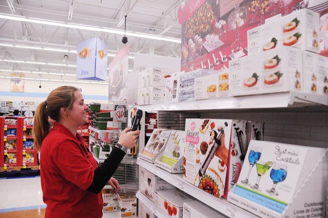 Allison Veenstar checks inventory at Meijer as the store gets ready for the holiday rush. Many stores are getting ready for the busiest shopping day of the year.