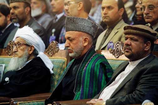 Afghan President Hamid Karzai (center), Afghan first vice
president Qasim Fahim (right) and chairman Sebghatullah Mujadidi,
attend a loya jirga, or grand council, in Kabul, Afghanistan,
Wednesday.