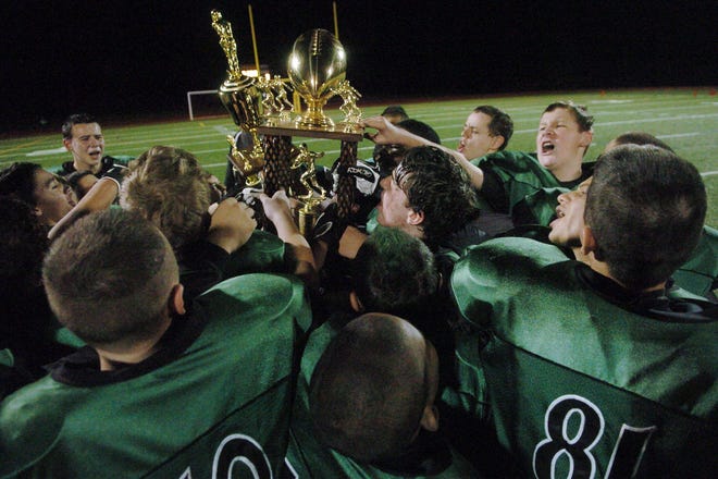 Griswold players celebrate their Southern New England Youth Football Conference Senior championship win over Westerly on Sunday at New London High School. The Wolverines won, 6-0.