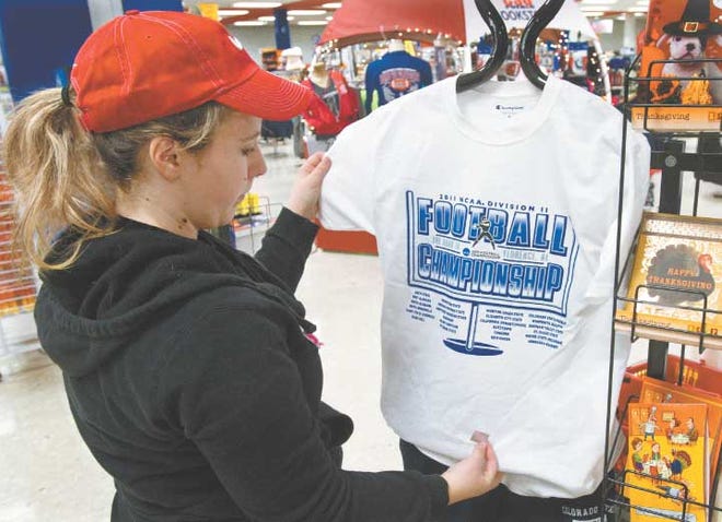 Colorado State University-Pueblo student worker Ashley Vincent
on Monday dresses a mannequin in a NCAA-licensed shirt honoring
teams in the Division II football playoffs, including CSU-Pueblo.
Fans continue to snap up ThunderWolves clothing and memorabilia
ahead of Saturday's home playoff game against Minnesota-Duluth.
Among the popular items are flags that can be displayed outside a
business or home, according to the bookstore. Fan items also are
available at sport stores across the city.