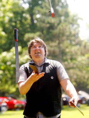 Brian Pankey juggles four machettes during the Williamsville Celebration on Saturday, June 26, 2010. Ted Schurter/The State Journal-Register