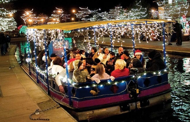Riverwalk patrons await a chilly tour of HARP via a boat ride
during the 11th annual Holiday Lighting Extravaganza last year.