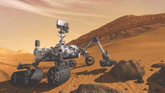 In this 2011 artist's rendering provided by NASA/JPL-Caltech,
the Mars Science Laboratory Curiosity rover examines a rock on Mars
with a set of tools at the end of its arm, which extends about 7
feet. The mobile robot is designed to investigate Mars' past or
present ability to sustain microbial life.