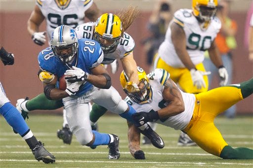 Detroit Lions running back Maurice Morris (28) is tackled by Green Bay Packers outside linebacker Clay Matthews (52) and linebacker Rob Francois (49) in the fourth quarter of an NFL football game in Detroit, Thursday, Nov. 24, 2011.