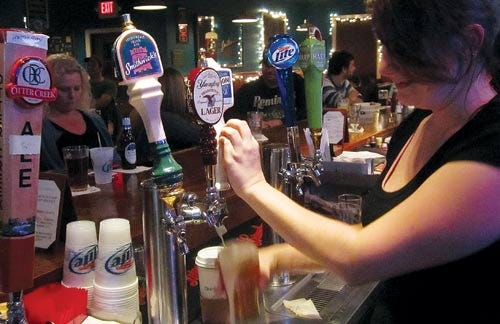 Photo by Steven Reilly/New Jersey Herald Evin Joice, manager of O’Reilly’s Pub and Grill in Newton, serves up a pint of lager Wednesday.