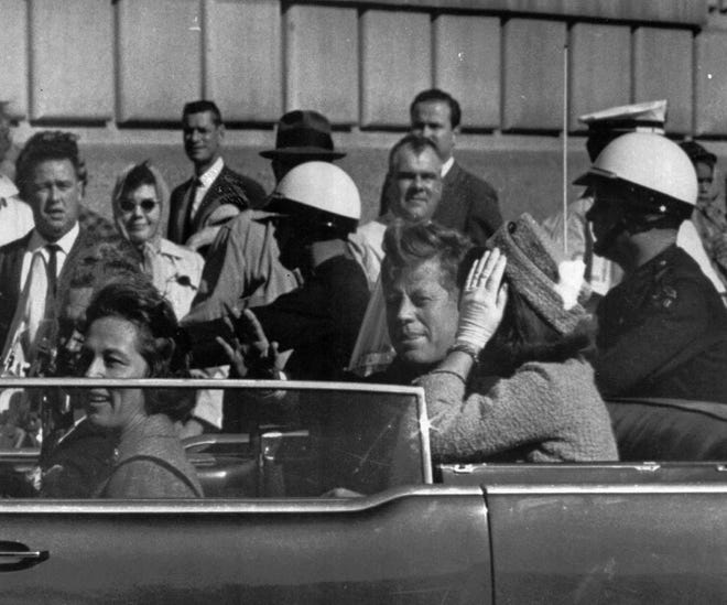 President John F. Kennedy rides in a motorcade with his wife Jacqueline moments before he was shot and killed in Dallas, Texas, Nov. 22, 1963. Texas Governor and Mrs. John Connally are also in the car.