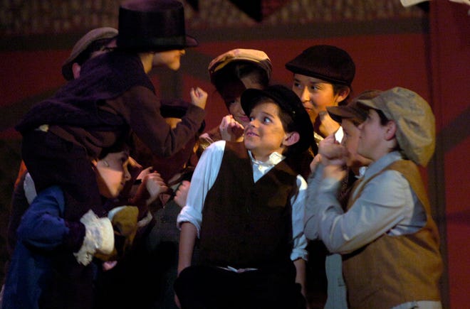 William Fafard, center, plays the title role of Oliver in the Theatre Company of Saugus production of “Oliver!”