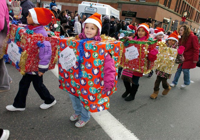 Paige Bartlett, 7, of Brockton walks with her Girl Scout troop at last year’s Brockton holiday parade.