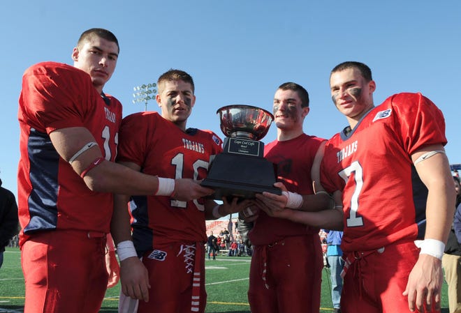 Cape Cod trophy is held by B-R players from left, Nick Schlatz, Branden Morin, Eric Demoura, and Brad Deluliis after the Trojans beat Brockton on Thursday in Bridgewater.
