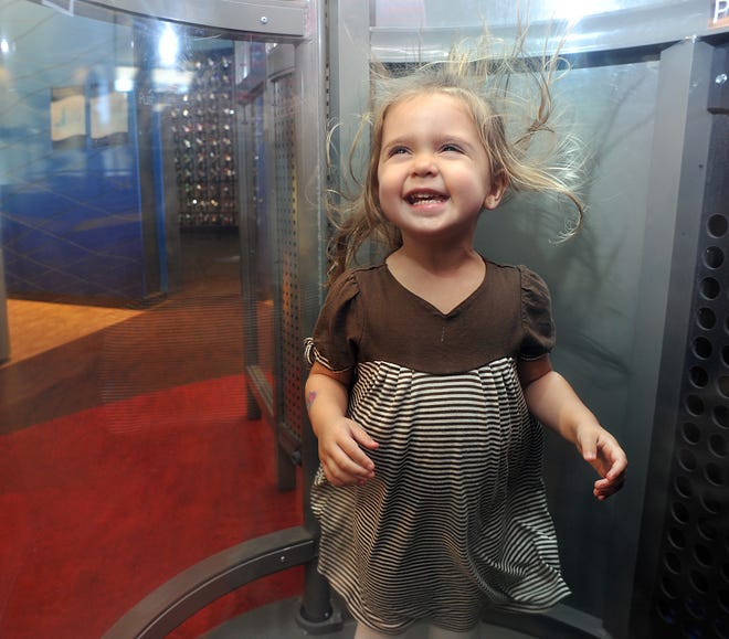 Brianna Brienne Belliveau, 2, of Holden, experiences 77 mph winds in a glass booth that is part of the exhibit “The Arctic Next Door” at the EcoTarium in Worcester.