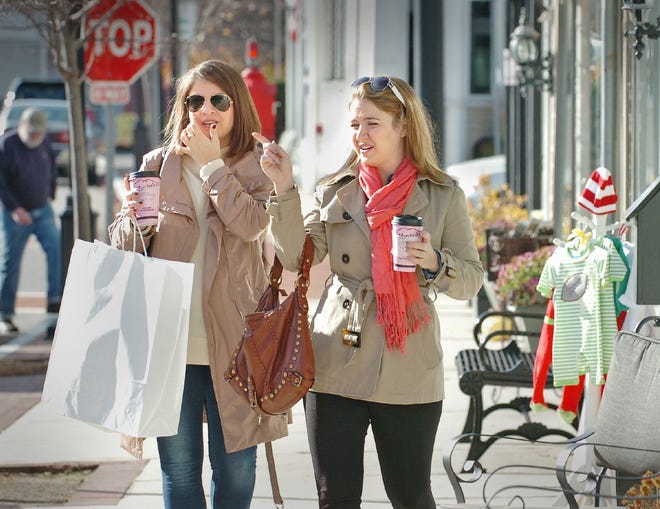 Sisters Christine, left, and Julia Lovallo of Cohasset shop in Hingham Square on Friday, Nov. 25, 2011, the day after Thanksgiving when retail shoppers flock to stores for bargains. The sisters said they had gone to a shopping mall earlier in the day.