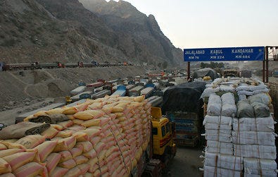 Trucks carrying logistic supplies for NATO's forces in Afghanistan wait for clearance to cross the border from Pakistan.