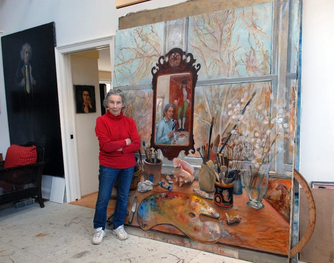 Truro artist Nancy Ellen Craig, 83, with one of four canvases in which the mirror reflects two of her self-portraits and the scene outside her studio reflects the season of the year.
