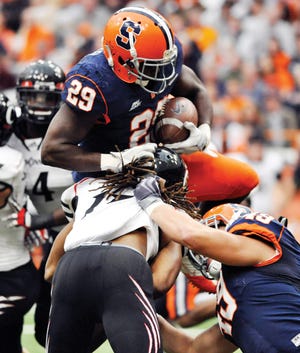 Syracuse's Antwon Bailey fights for extra yards against Cincinnati during the first quarter of an NCAA college football game in Syracuse, N.Y., Saturday, Nov. 26, 2011. (AP Photo/Kevin Rivoli)