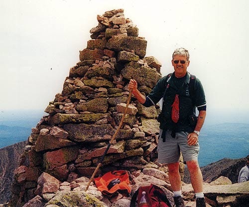 AP Photo/Courtesy of Nelson Daigle 
This photo provided by Nelson Daigle shows Daigle atop Maine’s highest peak, Mount Katahdin, in July 2002, his 143rd climb to its summit. Daigle has hiked the mountain more than 400 times and has been hiking it for only 17 years.