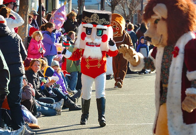 The Lion and Nutcracker greeted children along the Quincy Christmas parade route.