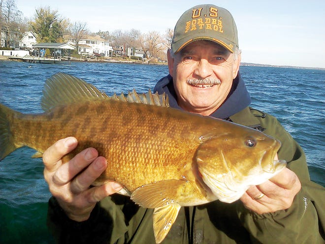 Peter Wolak found that the fishing is still good in Canandaigua Lake, recently catching 14 smallmouth bass. He is pictured with his biggest catch, which he estimated weighs at least six pounds.