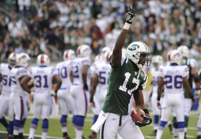 Jets wide receiver Plaxico Burress celebrates Sunday after scoring a touchdown against the Bills during the second quarter of their game in East Rutherford, N.J. New York won, 28-24.