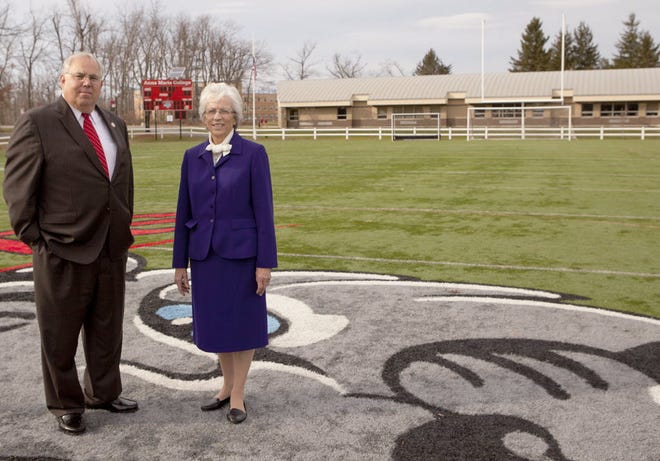 Anna Maria President Jack Calareso and Sister Rollande Quintal on the football field at Anna Maria College.