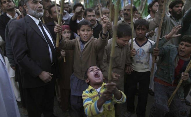 A Pakistani boy shouts slogans Sunday with other protesters during a rally to condemn NATO helicopters attacks on Pakistani troops.