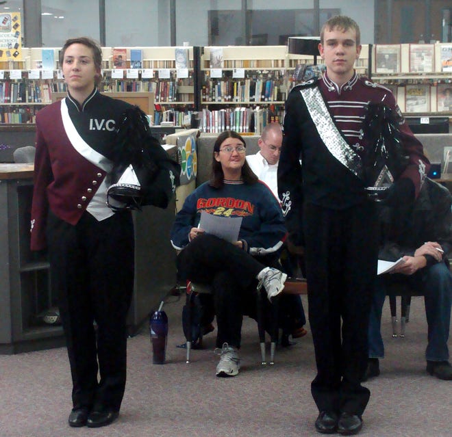 Kaitlyn Farris and Michael German show the two uniforms the band was considering purchasing. The new uniforms will look like the one German is wearing.