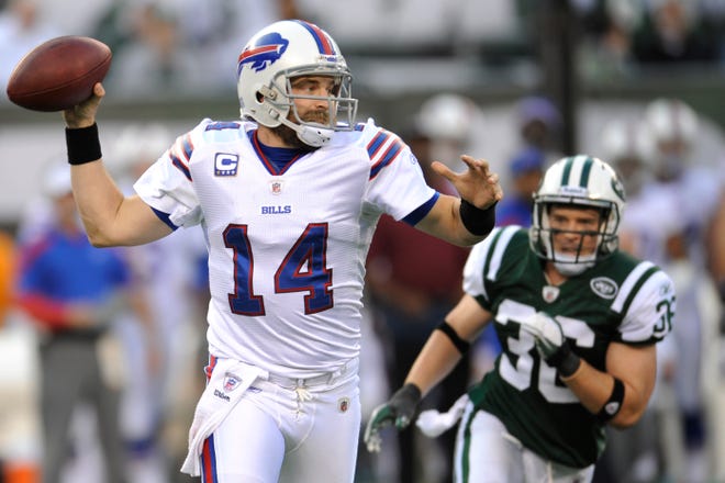 Buffalo Bills quarterback Ryan Fitzpatrick (14) looks to pass as New York Jets strong safety Jim Leonhard (36) runs in pursuit during the fourth quarter of an NFL football game Sunday, Nov. 27, 2011 in East Rutherford, N.J. The Jets won the game 28-24. (AP Photo/Bill Kostroun)