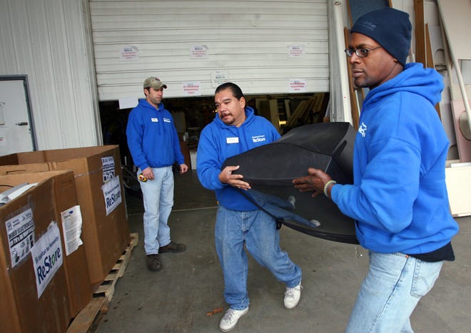 Manuel Cantu and Dave Chavis carry a television set to a bin Monday as they sort electronics that were dropped off during the weekend at the Habitat for Humanity of Sangamon County ReStore. Habitat expects the number of electronic items recycled at their store to increase after Jan. 1, when the the Illinois Electronic Products Recycling & Reuse Act takes effect.Ted Schurter/The State Journal-Register