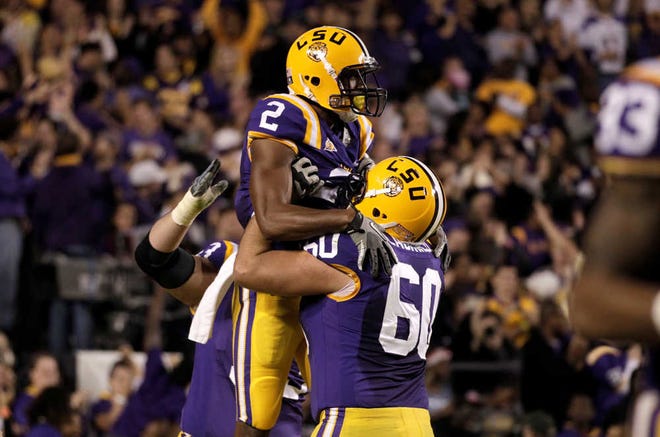 LSU wide receiver Rueben Randle (2) celebrates his 59-yard touchdown reception with teammate Will Blackwell (60 during the first quarter of their NCAA college football game against Western Kentucky in Baton Rouge, Saturday, Nov. 12, 2011. (AP Photo/Gerald Herbert)