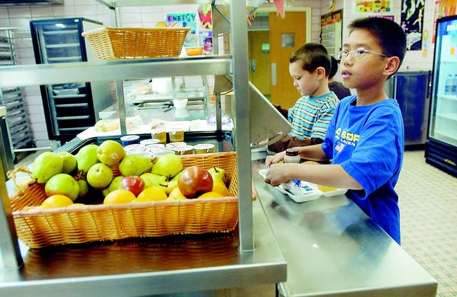 Jakob McNamara-Zito and Davis Le, right, fourth graders at Leary Elementary School, can now enjoy healthier lunches thanks to the districts efforts to combat obesity. Wheat bread, apples and low fat milk have replaced high calorie foods, snacks and soda.