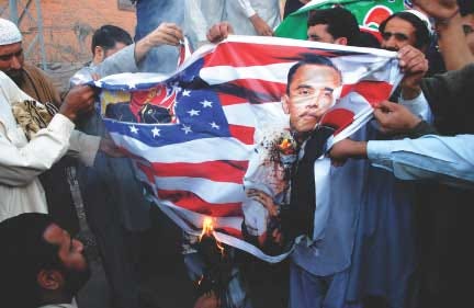 Pakistani protesters burn a representation of the U.S. flag
bearing a depiction of U.S. President Barack Obama, during an
anti-NATO rally in Peshawar, Pakistan, Tuesday.