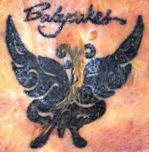 A butterfly tattoo (left) that's on the lower back of a woman whose body was found beside an Interstate 95 access ramp Wednesday, and one on her lower left leg.