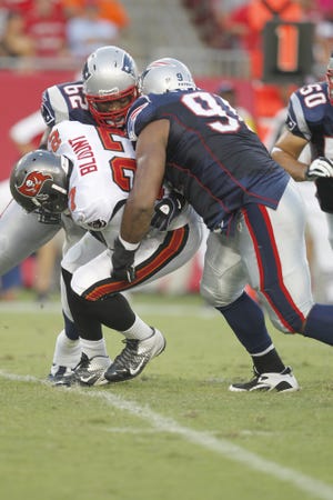 Patriots defensive tackle Myron Pryor (91) and center Ryan Wendell (62) bring down Tampa Bay Buccaneers running back LeGarrette Blount (27) during a preseason game on Aug. 18 in Tampa.