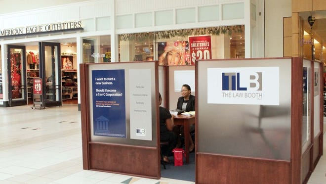 Attorney Melva Rozier meets with a client at The Law Booth in the Boynton Beach Mall.