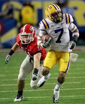 LSU cornerback Tyrann Mathieu (7) returns a punt for a touchdown as Georgia's Connor Norman defends during the first half of the Southeastern Conference championship NCAA college football game, Saturday, Dec. 3, 2011, in Atlanta. (AP Photo/John Bazemore)