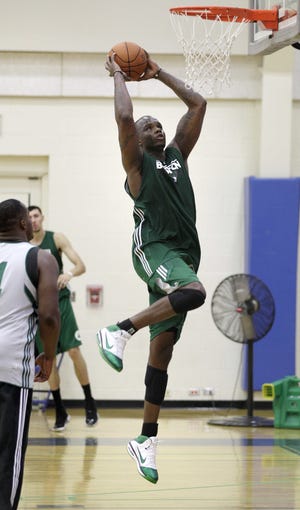 Boston Celtics forward Jermaine O'Neal, right, gets past forward Glen Davis, left, as he goes up for a dunk during their practice at the team's training camp at Salve Regina University in Newport, R.I., Tuesday, Sept. 28, 2010.(AP Photo/Charles Krupa)