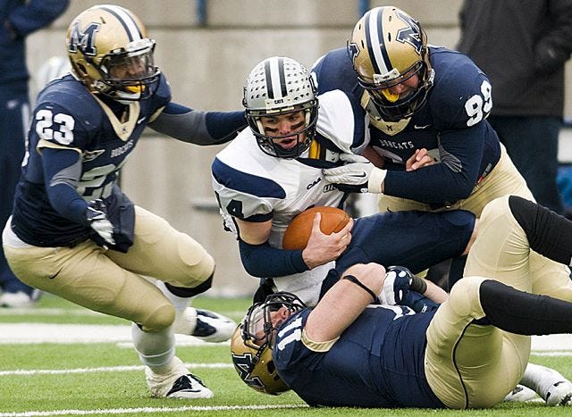 AP photo
UNH quarterback Kevin Decker is sacked by Montana State's Jody Owens (23), John Laidet (11), and Brian Bignell (99) during the NCAA playoffs Saturday in Bozeman, Mont.