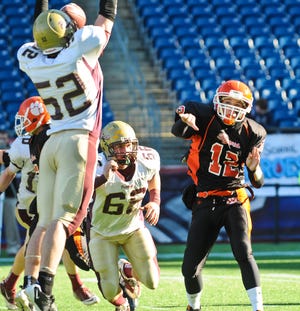Oliver Ames quarterback Jared Schneider's pass is blocked by Concord-Carlisle during the Div. 3 Superbowl at Gillette Stadium Saturday morning. Concord-Carlisle won 42-9. Photo by Ashley McCabe