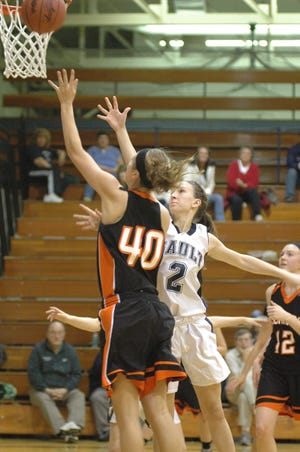 Olivia Nash of Escanaba is defended by Sault High's Cassie Metrish during Saturday's basketball game.