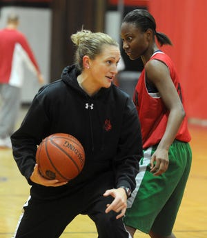 Head coach April Dingwell, left, works with Chantel Jordan as she instructs her players how to go around an opponent during the Boxers' practice on Tuesday.