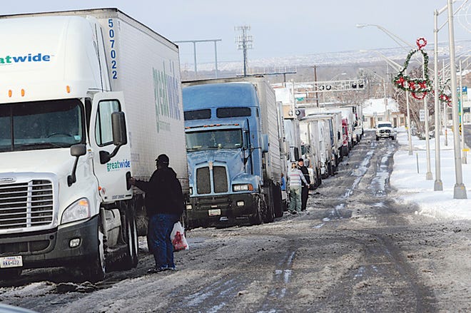 Truckers line up along California Street in Socorro, N.M. to await the re-opening of the southbound lane of Interstate 25 on Monday afternoon. Severe winter blast struck most of New Mexico on Monday, closing hundreds of schools and shutting down I-40 from Albuquerque to Gallup that forced motorists to seek emergency shelter, including Pekin resident Bobbi Prather.